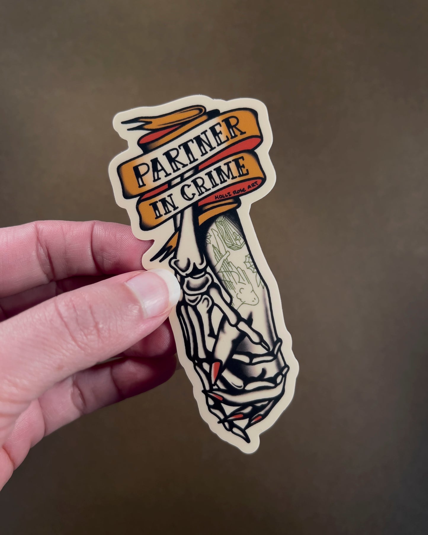 Sticker with the saying 'Partner in Crime' and a skeleton hand and human hand holding hands