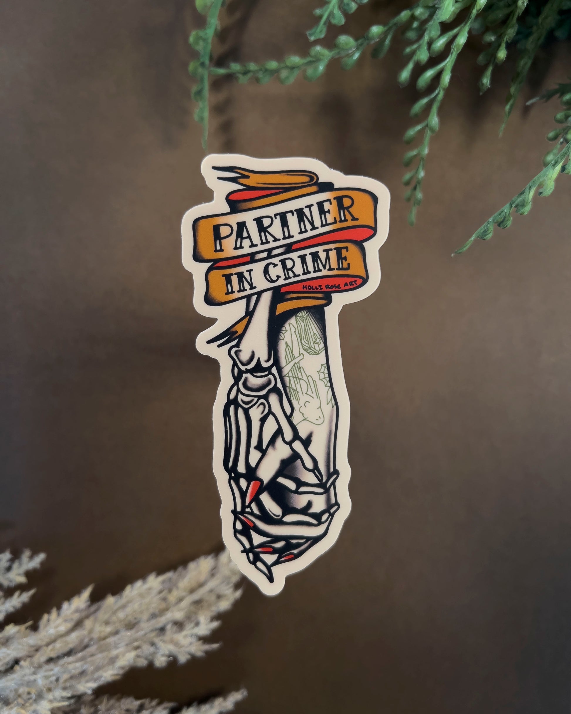 Sticker with the saying 'Partner in Crime' and a skeleton hand and human hand holding hands