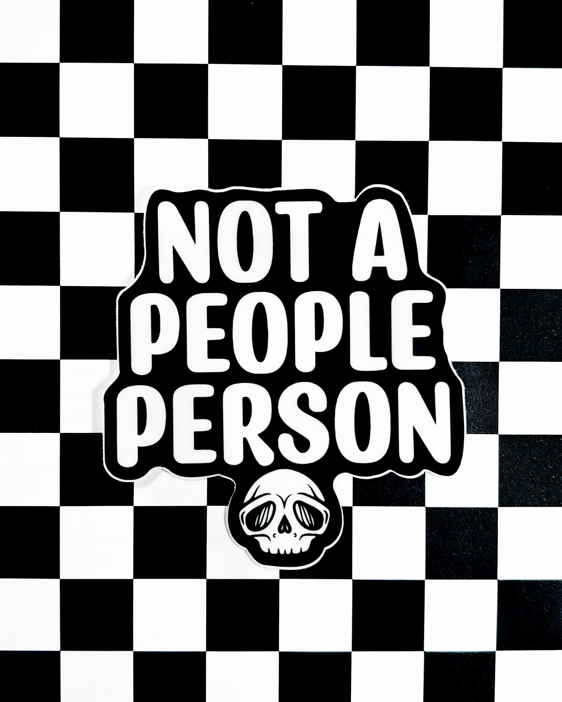 Sticker with 'Not a People Person' text on a black and white checkered background