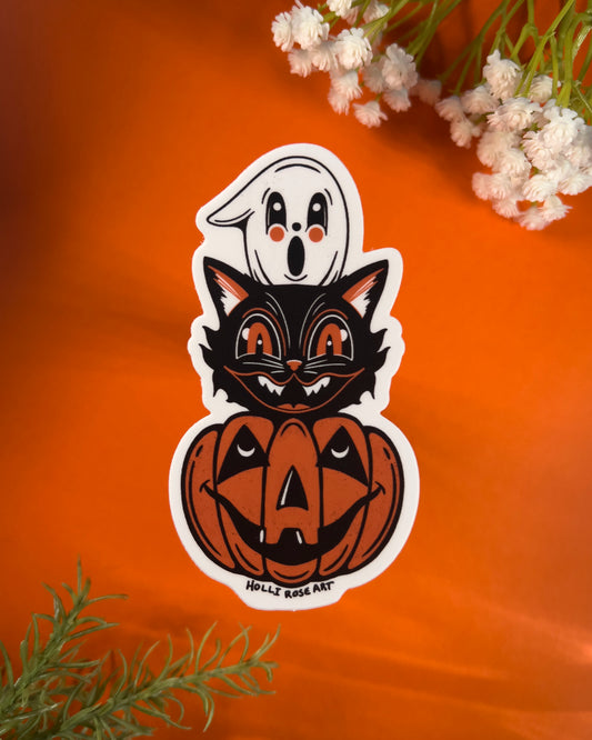Halloween-themed sticker with a black cat, ghost, and pumpkin on an orange background.