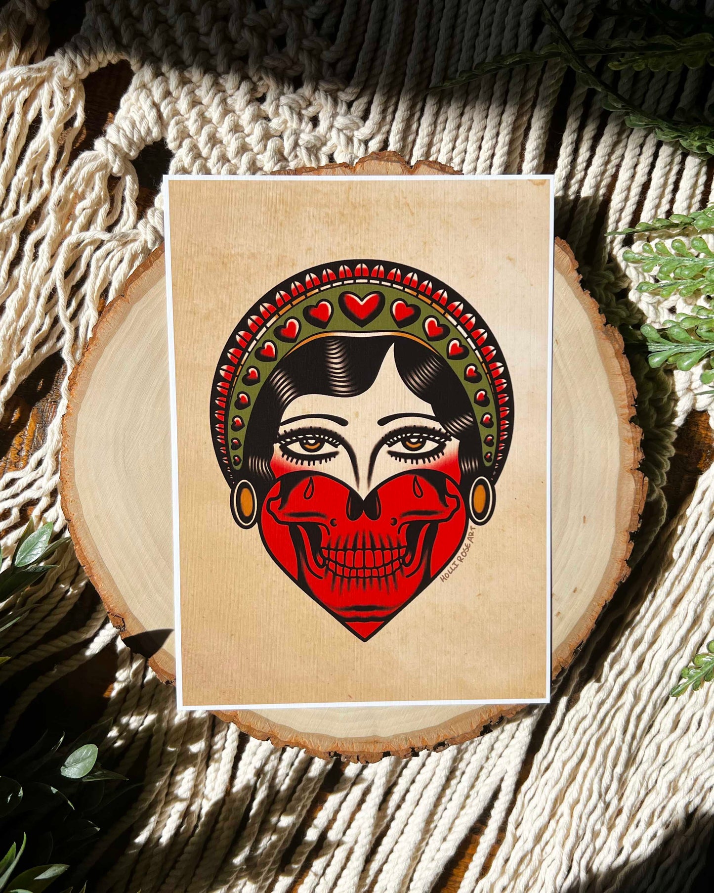 print of an American traditional girl face on the top and a skull jaw in a hard at the bottom