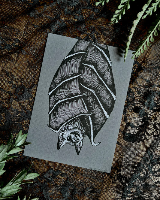 art print of a bat hanging upside down