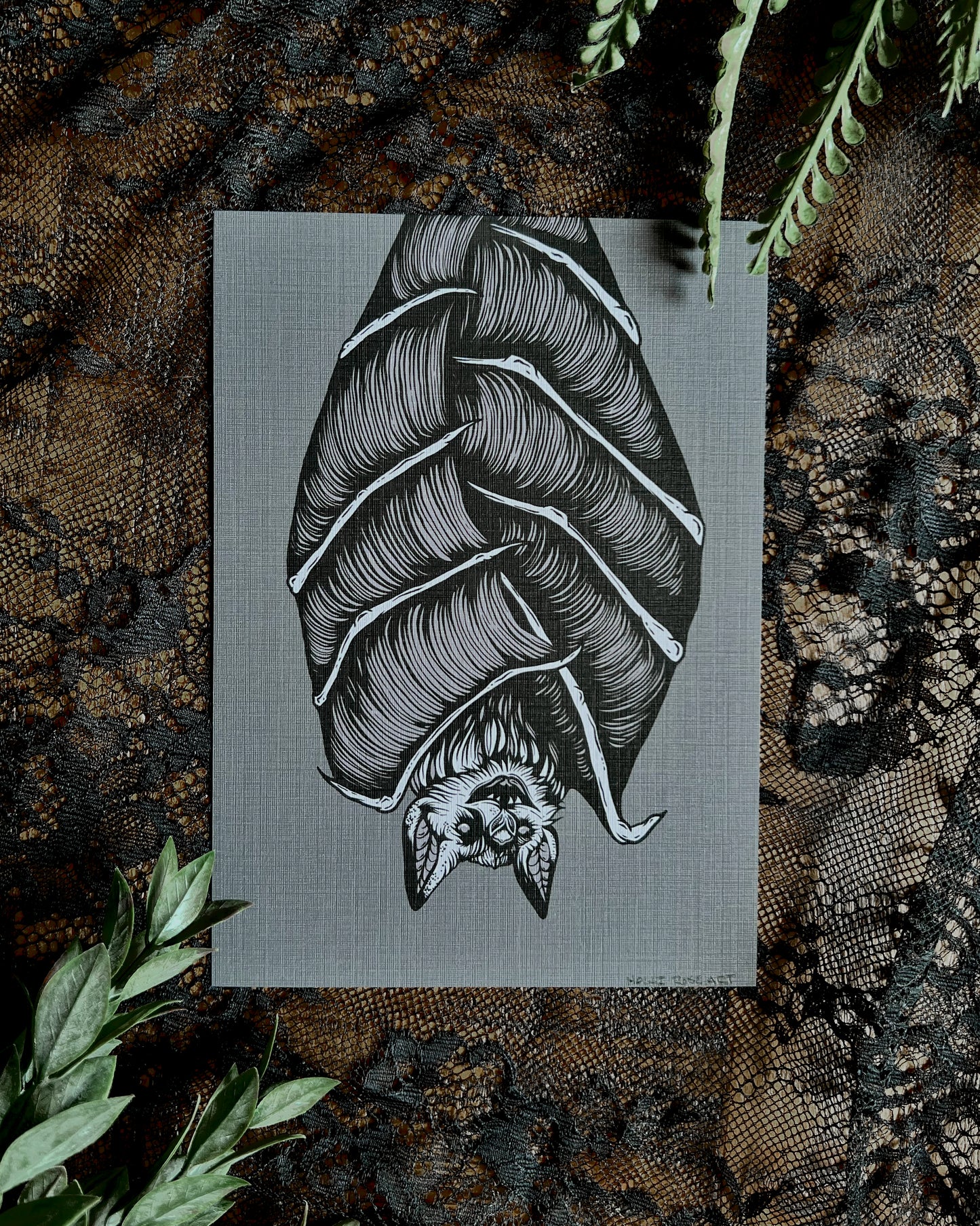 art print of a bat hanging upside down