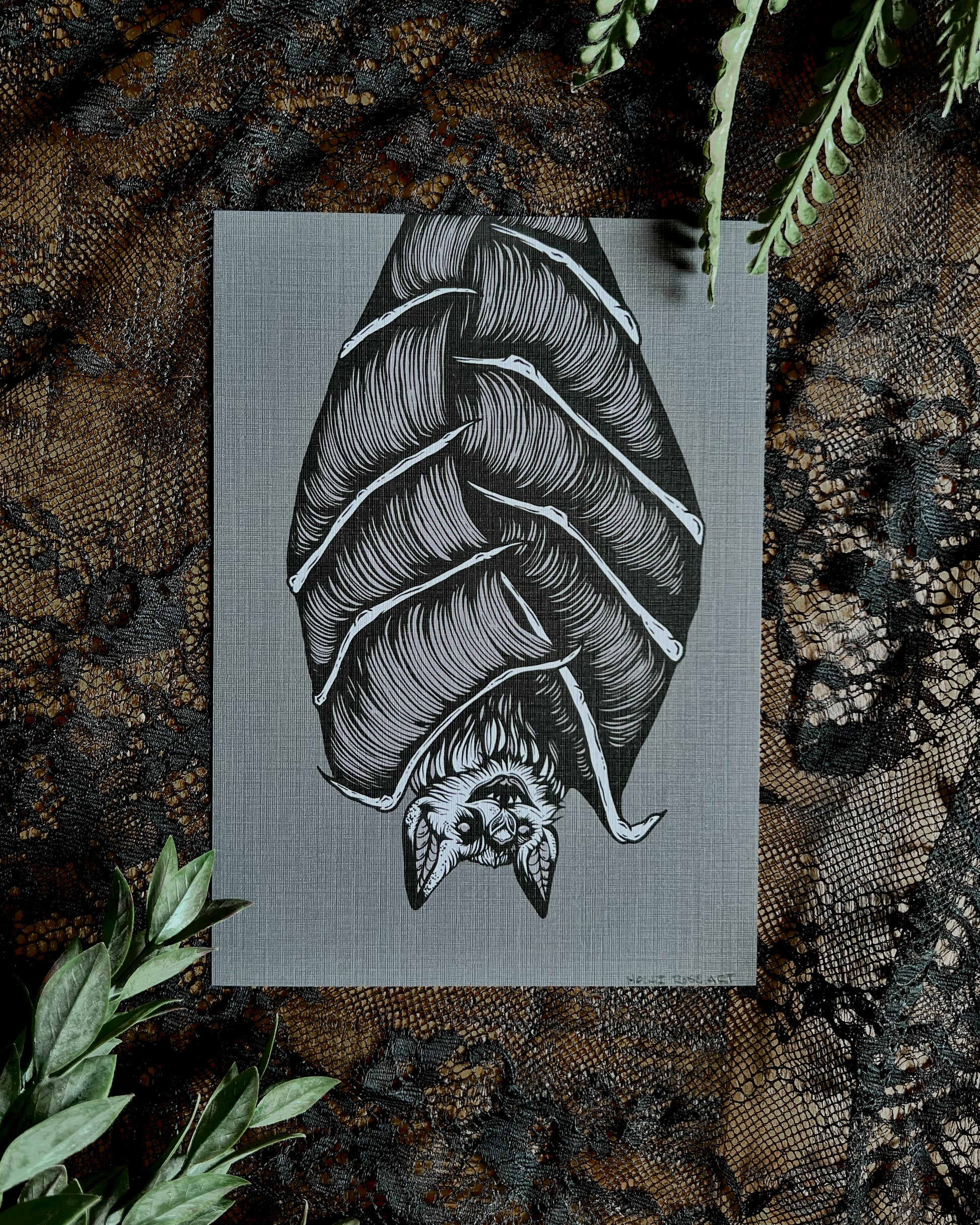 art print of a bat hanging upside down