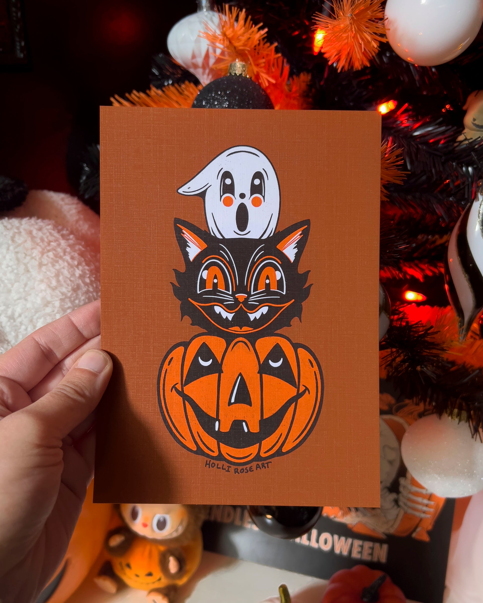 Halloween themed drawing art print with a ghost, cat and pumpkin head stacked on eachtoher
