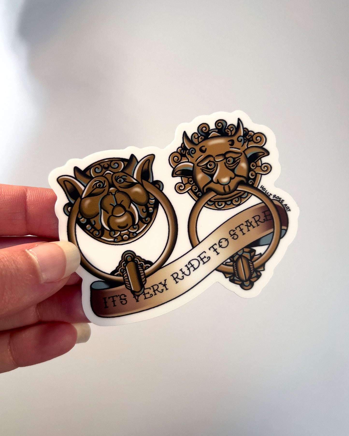 sticker of labyrinth doorknockers and the saying "it's very rude to stare"