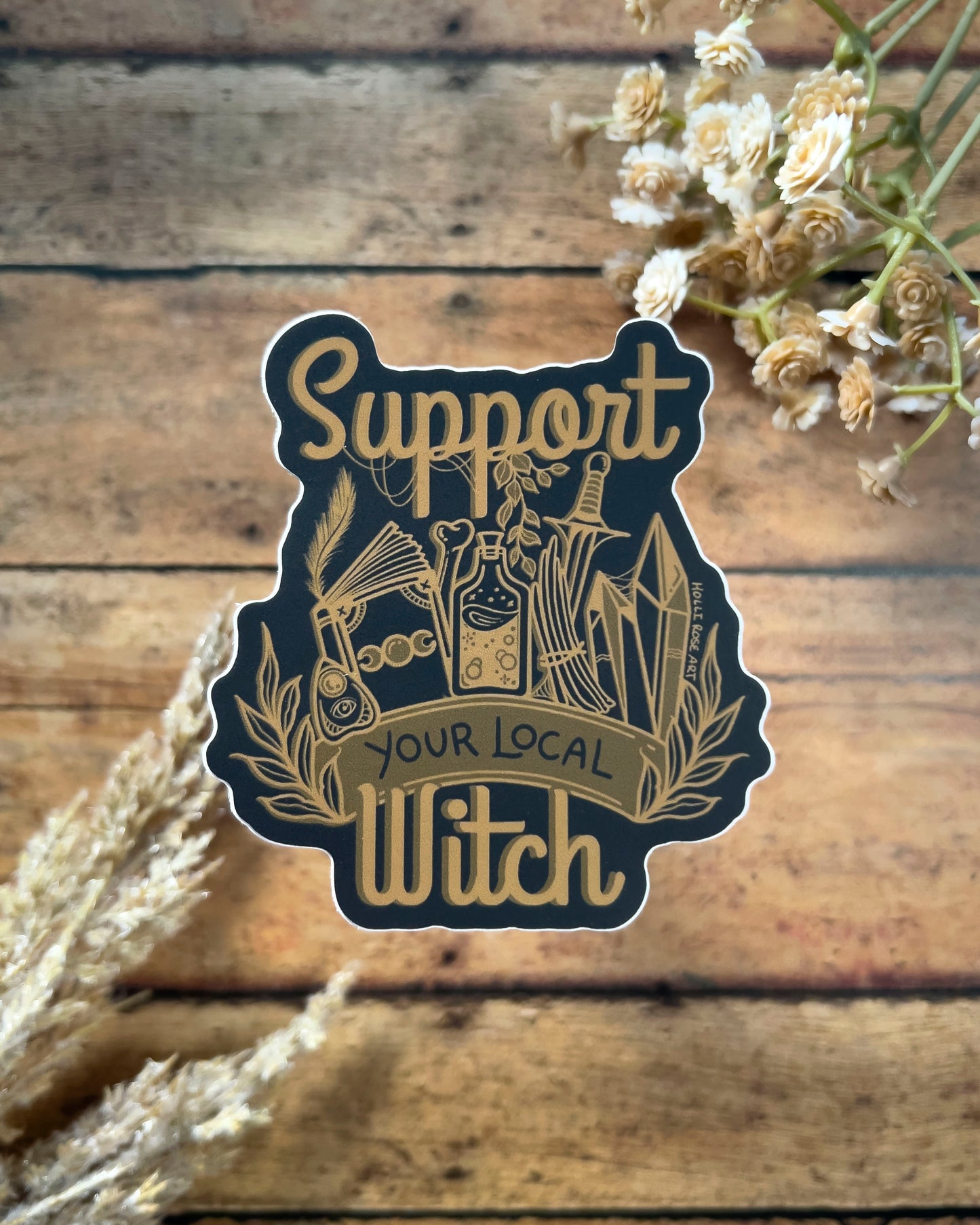 a sticker that says support your local witch with witchy elements 