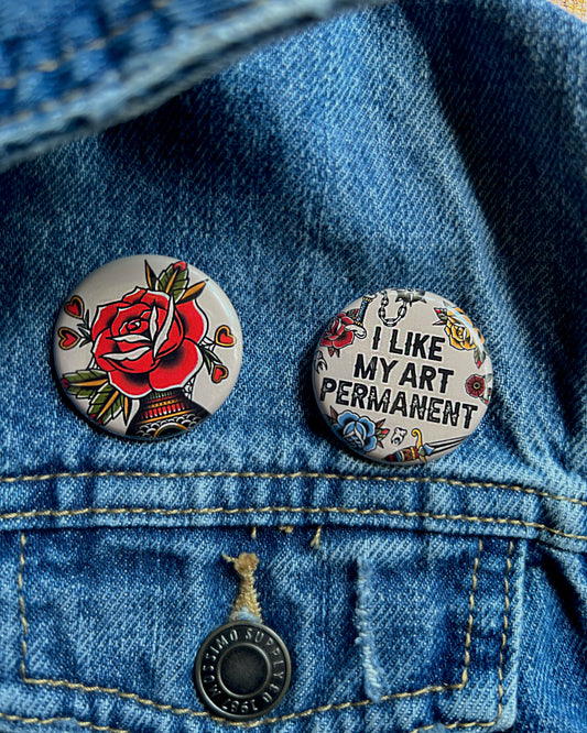 2 buttons on a jean jacket about tattoos