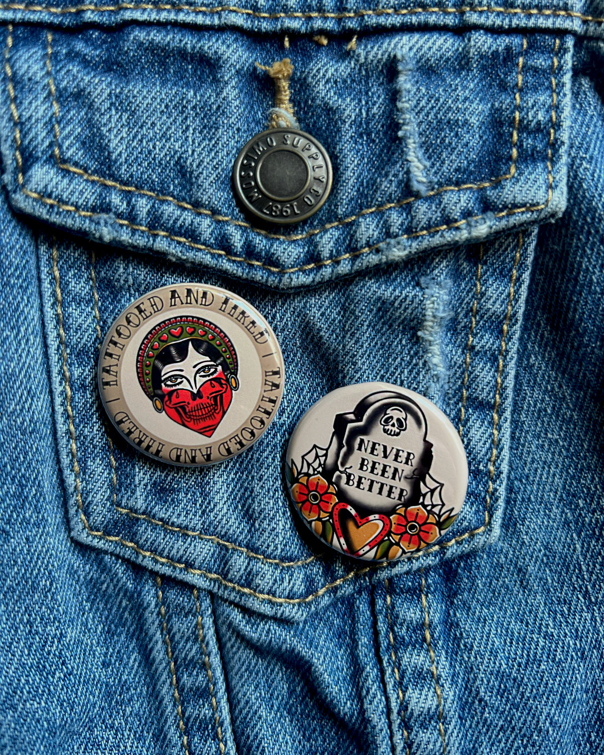 2 buttons on a jean jacket about tattoos