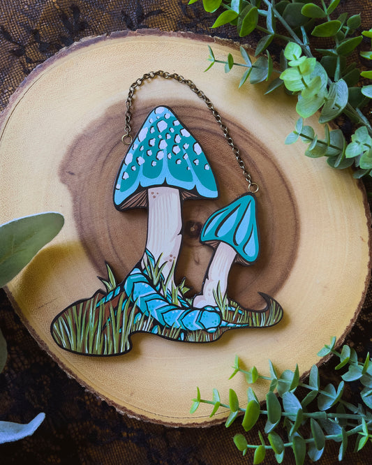 hand painted hanging of teal mushrooms and a teal centipede