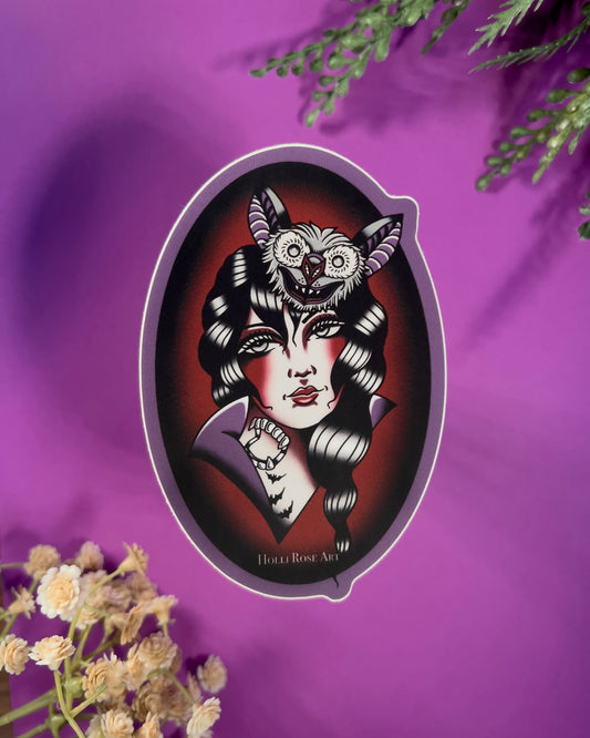 sticker with an American traditional vampire girl and a bat on her head in an oval shape and is purple and red