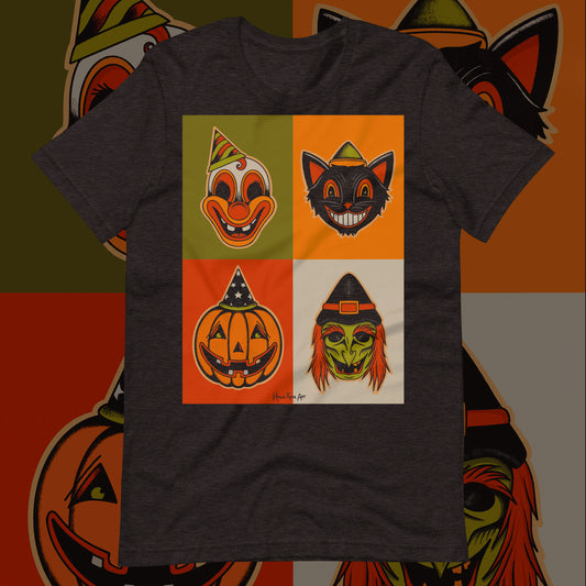 A dark grey t-shirt featuring a square arrangement of four different classic Halloween mask designs, including a pumpkin, a clown, a witch, and a cat