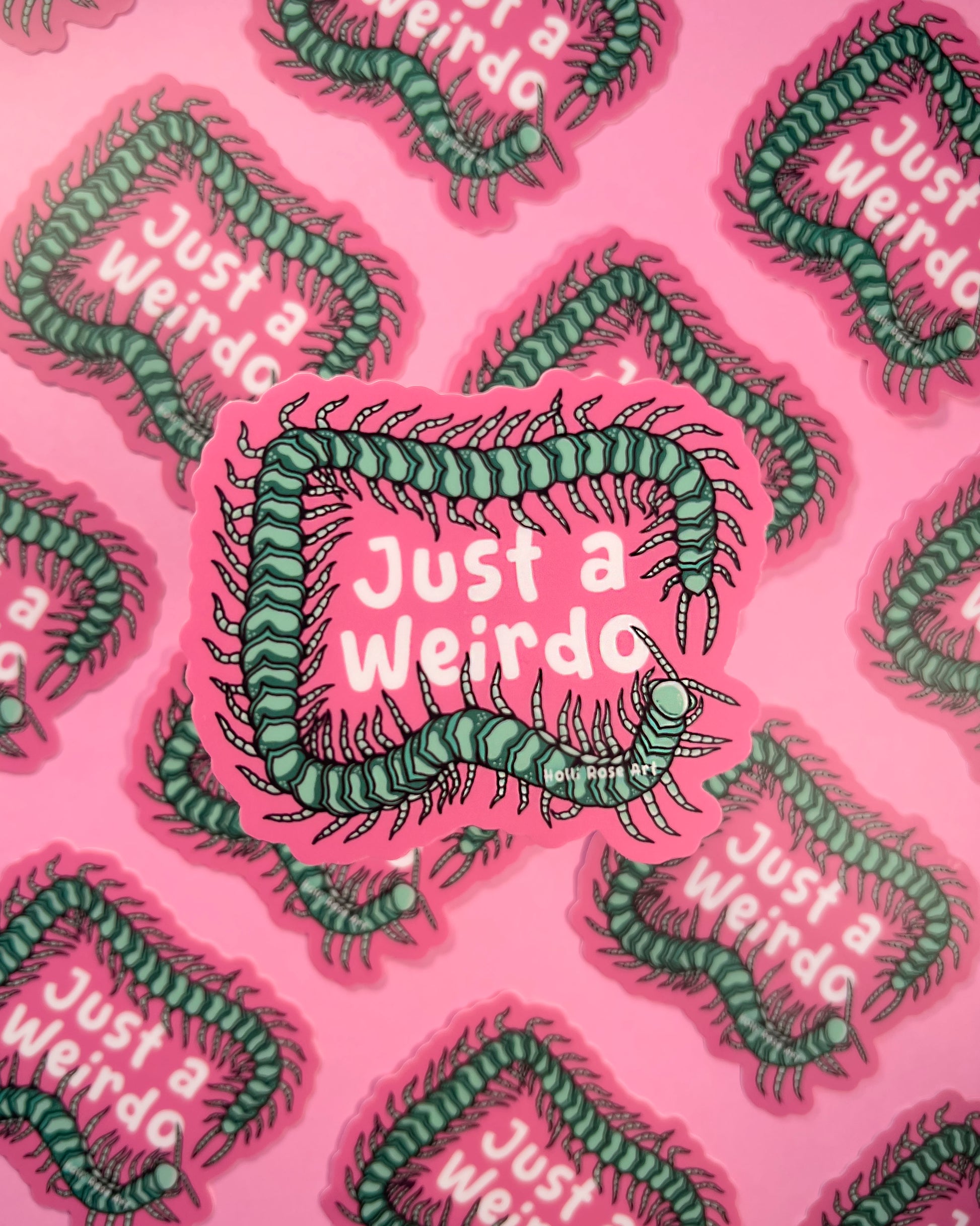 sticker with a green centipede with 'Just a Weirdo' text on a pink background