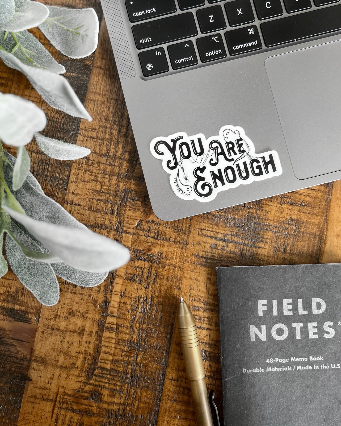 a sticker saying you are enough with ghosts